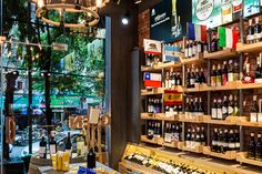 a wine shop filled with lots of bottles and glasses