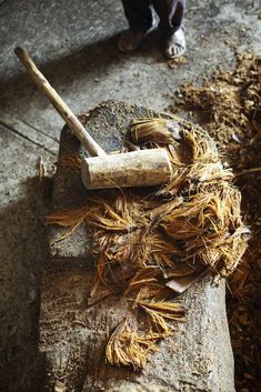 a wooden mallet and some wood shavings on top of a piece of wood