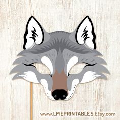 a paper wolf mask is shown on a wooden background with the words, free printables easy