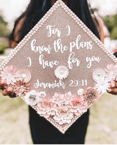 a woman holding up a graduation cap that says for i know the plans i have for you