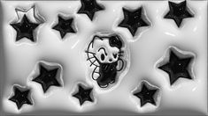 black and white photo of hello kitty cookies with stars around it in the shape of cats