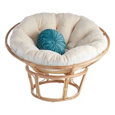 a round chair with a blue pillow on it's back and seat cushion in the middle