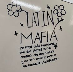 a white refrigerator with writing on it and flowers drawn on the door handle in spanish