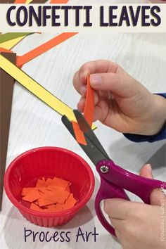 someone is cutting up pieces of construction paper with scissors to make a craft for kids