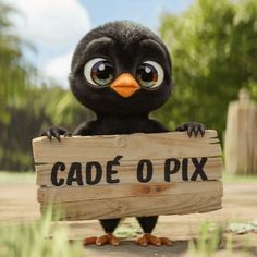 a black bird holding a wooden sign that says cade o pix