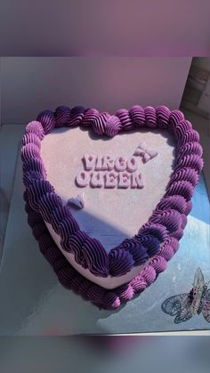 a heart shaped cake with the words sorry queen written on it in purple icing