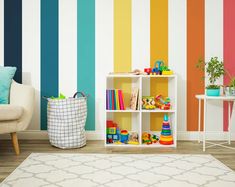 a living room with colorful striped wallpaper and toys on the shelves in front of it