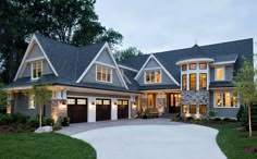 a large house with lots of windows and lights