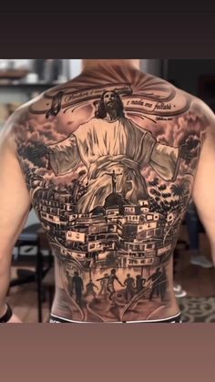 the back of a man's body with tattoos on it, and an image of jesus