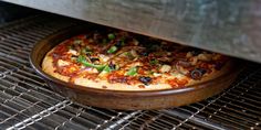 a pizza sitting on top of a pan in an oven