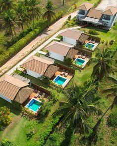 an aerial view of several houses with swimming pools