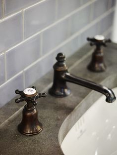 two faucets are shown in this bathroom sink