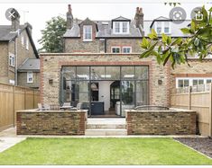 a brick house with glass doors and windows