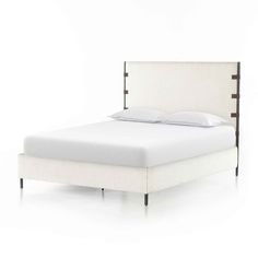 the bed is made up with white linen