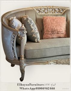 a couch with some pillows on it and a pillow in front of the couch is an ornate frame