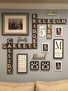 a living room filled with lots of pictures and frames on the wall next to a couch