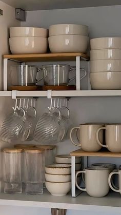 the shelves are filled with dishes and cups