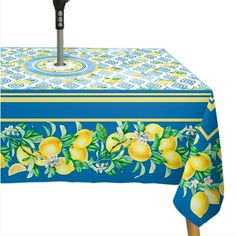 a blue and yellow table cloth with lemons on it