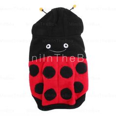 a black and red ladybug mitt with polka dots on the front, sitting in