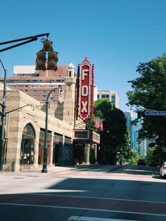 an empty city street with cars parked on the side