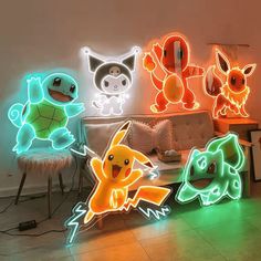 the pokemon light up signs are on display in front of a couch and table with chairs