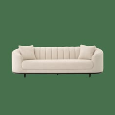 a white couch with two pillows on it