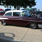 an old car is parked in a parking lot