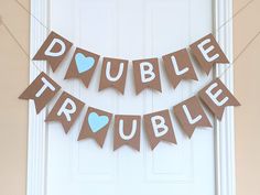 a couple of buntings that are hanging on a door frame with hearts and words