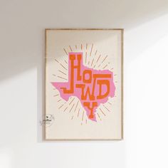 a pink and orange art piece hanging on the wall