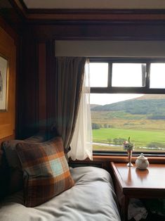 a bed sitting next to a window in a bedroom