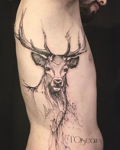 a deer tattoo on the side of a woman's thigh