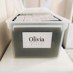 a plastic storage container with the name ollivia grace written in black on it