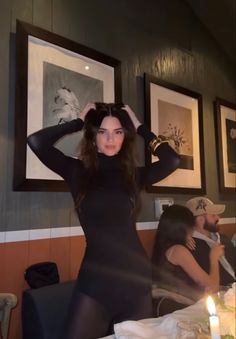 a woman standing in front of a table with plates and cups