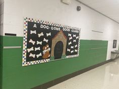 a dog gone class bulletin board on the wall in a school hallway with green and white walls