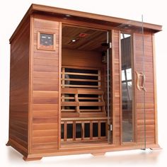 a wooden sauna with glass doors on the inside and outside side, in front of a white background