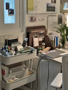 a desk with many items on it and a lamp in the corner next to it