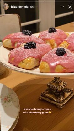 there are many pastries on the plate and one is covered in pink icing