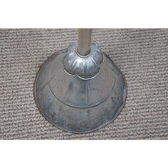 a metal object sitting on top of a carpeted floor