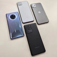 four different models of the same cell phone on a white surface with an apple logo