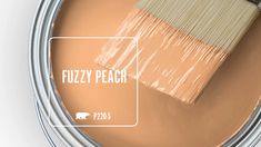 a paint can with a brush in it and the words fuzzy peach painted on it