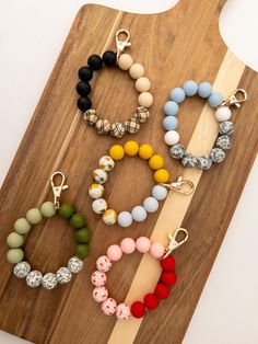 several different bracelets on a wooden board