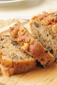 sliced loaf of banana nut bread sitting on top of a cutting board