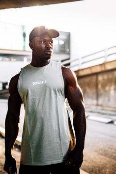 a man standing in front of a train station with his hands on his hips and looking at the camera