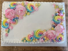 there is a cake decorated with flowers and icing on the table, ready to be eaten