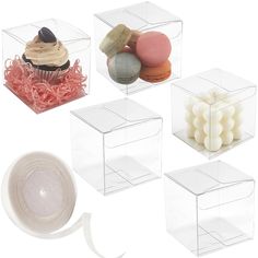 four clear boxes with different types of cupcakes and candies in them on a white background