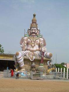 a large statue sitting in the middle of a parking lot