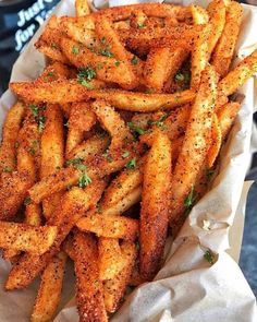 french fries with parsley on top in a basket