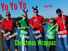 a group of people standing next to each other wearing christmas shirts and reindeer antlers