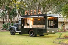 a food truck parked in front of a tree