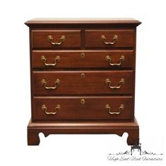 a wooden dresser with four drawers and brass knobs on the bottom drawer, against a white background